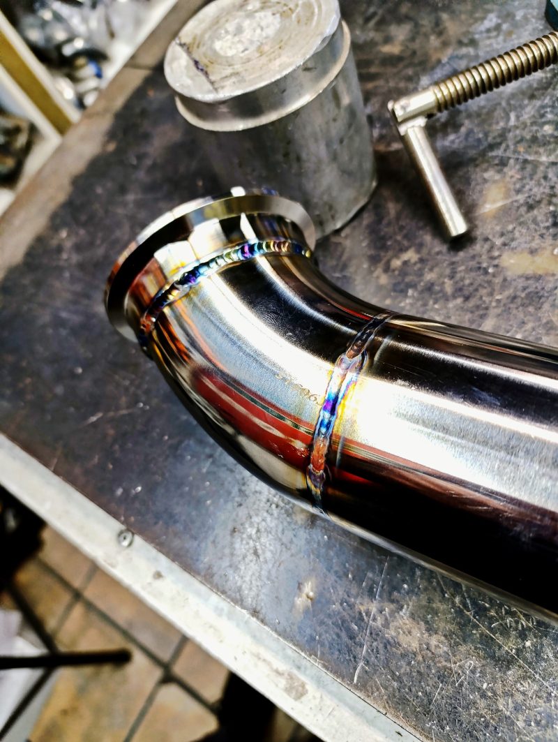 Close-up of a hand-finished TIG-welded SNIPER stainless exhaust pipe