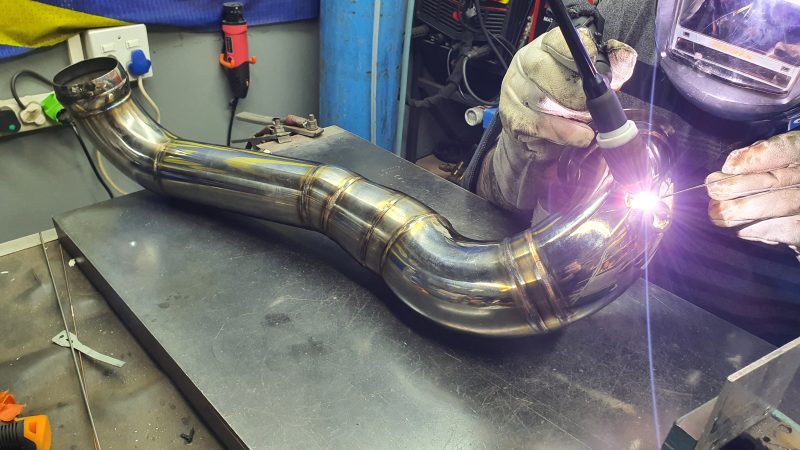 SNIPER fabricator TIG welding a stainless performance pipe by hand